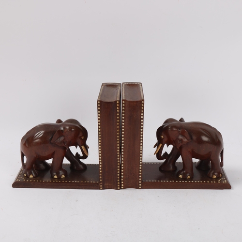 130 - A pair of Ceylonese early 20th century hardwood elephant design puzzle bookends, with secret compart... 