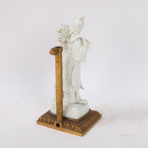 146 - A Chinese Magu figure lamp, white glaze porcelain, Qing Dynasty, on gilt-metal stand, height 18cm