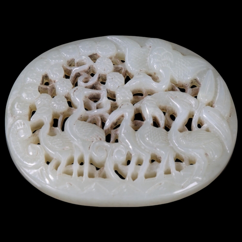 149 - A Chinese relief carved and pierced jade pendant, stork design, Qing Dynasty, 6.5cm x 5.5cm