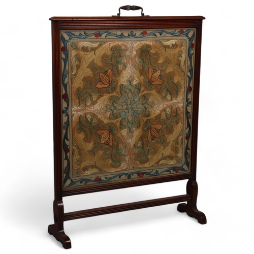 99 - A large 19th century Arts and Crafts walnut framed fire screen, with original embroidered panel in t... 