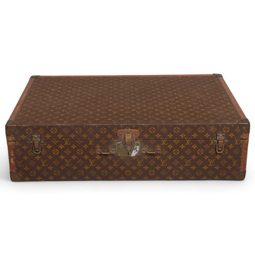 166 - LOUIS VUITTON - hard suitcase/trunk with monogram fabric cover, strapping to corners and brass locks... 