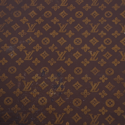 167 - LOUIS VUITTON - a hard suitcase/trunk with monogrammed fabric cover, leather edging, brass locks and... 