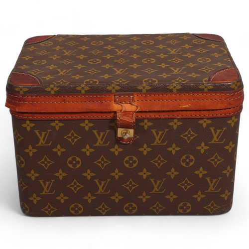 168 - LOUIS VUITTON - a vanity case with monogrammed fabric and cotton interior, brown leather edging and ... 