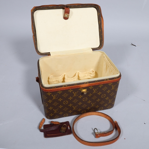 168 - LOUIS VUITTON - a vanity case with monogrammed fabric and cotton interior, brown leather edging and ... 