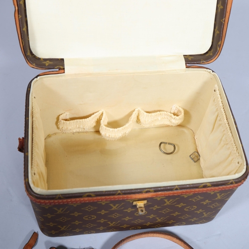 168 - LOUIS VUITTON - a vanity case with monogrammed fabric and cotton interior, brown leather edging and ... 