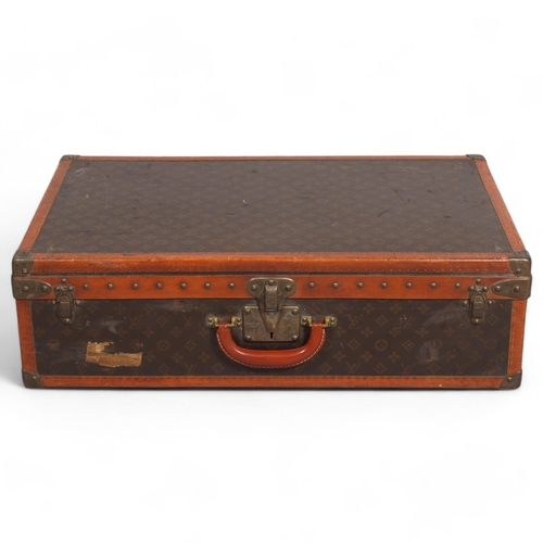 170 - LOUIS VUITTON - a hard suitcase/trunk with monogrammed fabric, edging, brass mounts and locks, label... 