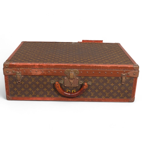 171 - LOUIS VUITTON - a hard suitcase/trunk with monogrammed fabric, leather edging and brass corner mount... 