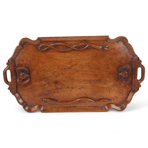 174 - An unusual hardwood carved tray with bats and snakes carved to central panel, length 61cm, width 33c... 