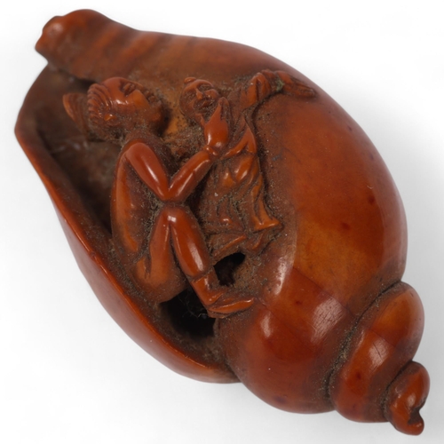 176 - A miniature Japanese Meiji period boxwood carving of figure emerging from conch shell, carved flower... 