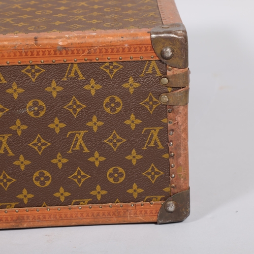 166 - LOUIS VUITTON - hard suitcase/trunk with monogram fabric cover, strapping to corners and brass locks... 