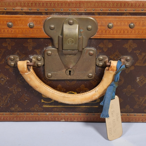 167 - LOUIS VUITTON - a hard suitcase/trunk with monogrammed fabric cover, leather edging, brass locks and... 