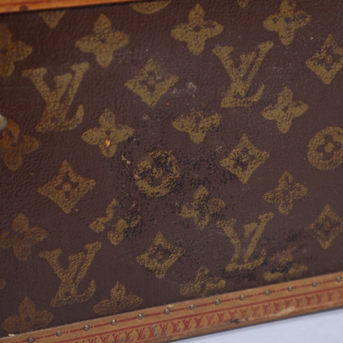 167 - LOUIS VUITTON - a hard suitcase/trunk with monogrammed fabric cover, leather edging, brass locks and... 