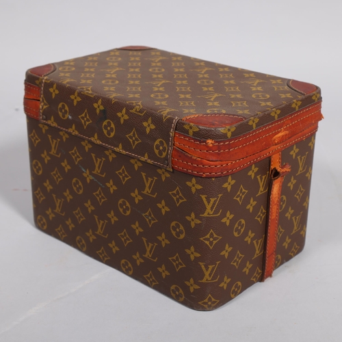 168 - LOUIS VUITTON - a vanity case with monogrammed fabric and cotton interior, brown leather edging and ... 