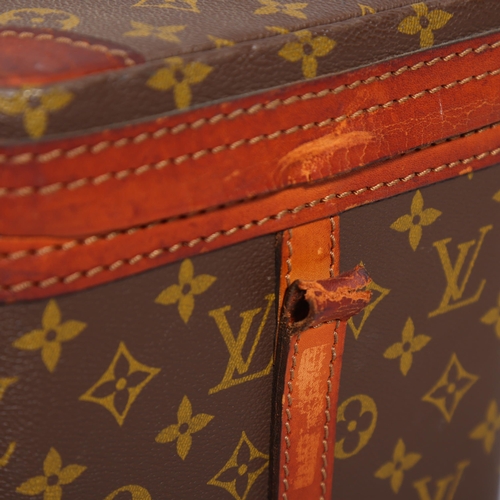 168 - LOUIS VUITTON - a vanity case with monogrammed fabric and cotton interior, brown leather edging and ... 