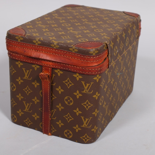 168 - LOUIS VUITTON - a vanity case with monogrammed fabric and cotton interior, brown leather edging and ... 