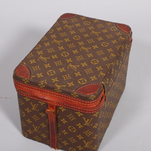 168 - LOUIS VUITTON - a vanity case with monogrammed fabric and cotton interior, brown leather edging and ... 