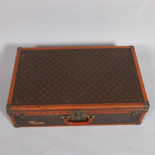 170 - LOUIS VUITTON - a hard suitcase/trunk with monogrammed fabric, edging, brass mounts and locks, label... 