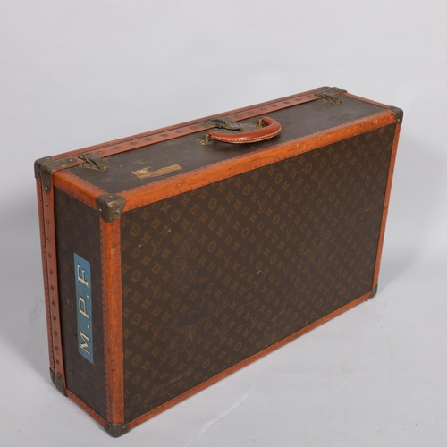 170 - LOUIS VUITTON - a hard suitcase/trunk with monogrammed fabric, edging, brass mounts and locks, label... 