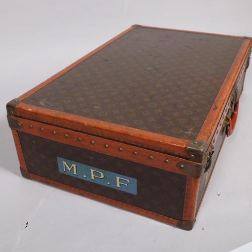 170 - LOUIS VUITTON - a hard suitcase/trunk with monogrammed fabric, edging, brass mounts and locks, label... 