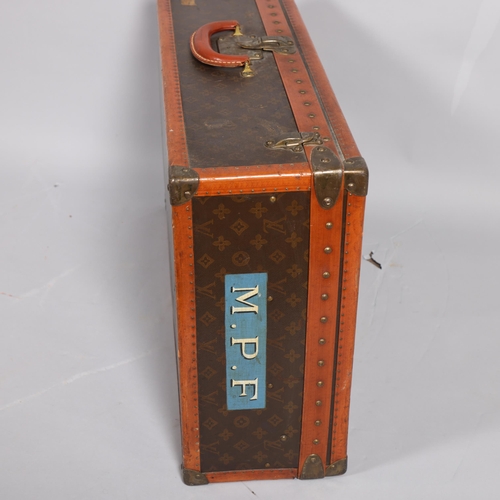 170 - LOUIS VUITTON - a hard suitcase/trunk with monogrammed fabric, edging, brass mounts and locks, label... 