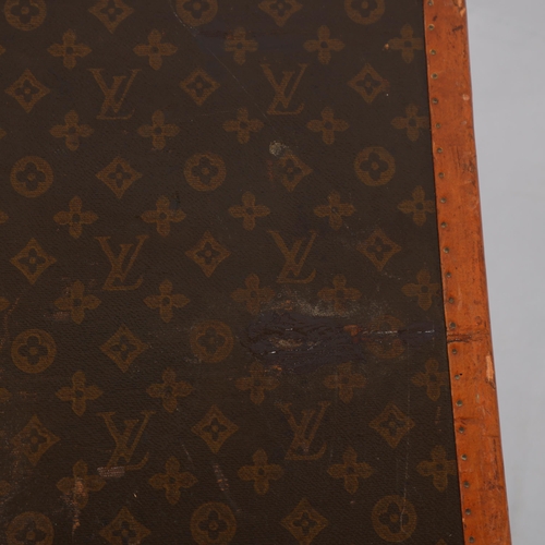 170 - LOUIS VUITTON - a hard suitcase/trunk with monogrammed fabric, edging, brass mounts and locks, label... 