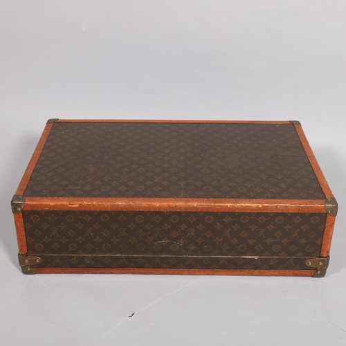 170 - LOUIS VUITTON - a hard suitcase/trunk with monogrammed fabric, edging, brass mounts and locks, label... 