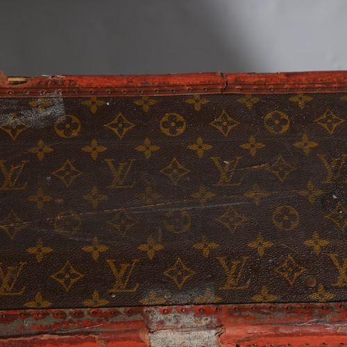 171 - LOUIS VUITTON - a hard suitcase/trunk with monogrammed fabric, leather edging and brass corner mount... 