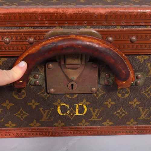 171 - LOUIS VUITTON - a hard suitcase/trunk with monogrammed fabric, leather edging and brass corner mount... 