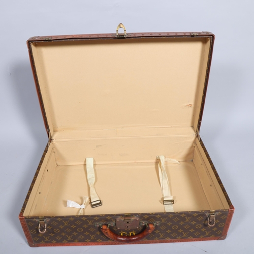 171 - LOUIS VUITTON - a hard suitcase/trunk with monogrammed fabric, leather edging and brass corner mount... 