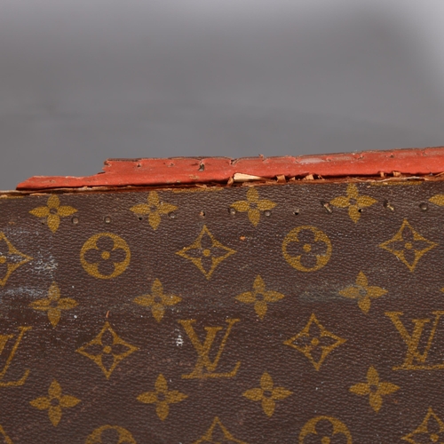 171 - LOUIS VUITTON - a hard suitcase/trunk with monogrammed fabric, leather edging and brass corner mount... 