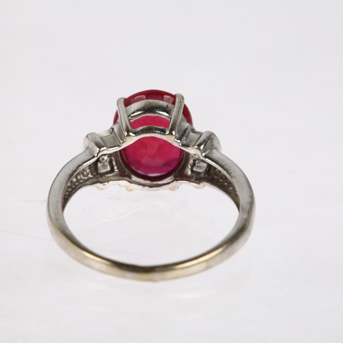 1379 - A modern 18ct white gold ruby and diamond dress ring, claw set with 2.7ct oval mixed-cut ruby flanke... 