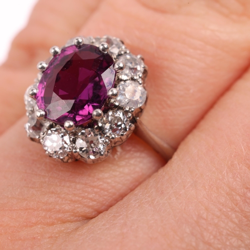 1406 - A platinum synthetic ruby and diamond flowerhead cluster ring, claw set with oval mixed-cut syntheti... 