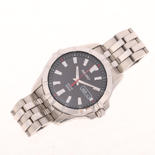 1024 - SEIKO - a stainless steel Solar 100M quartz day/date bracelet watch, ref. V158-0AH0, black dial with... 