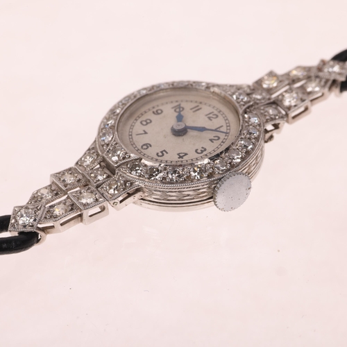 1060 - A lady's Art Deco platinum diamond mechanical cocktail wristwatch, circa 1930s, silvered dial with b... 