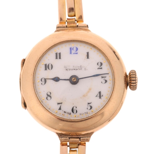 1064 - An early 20th century lady's 9ct gold mechanical bracelet watch, white enamel dial with hand painted... 