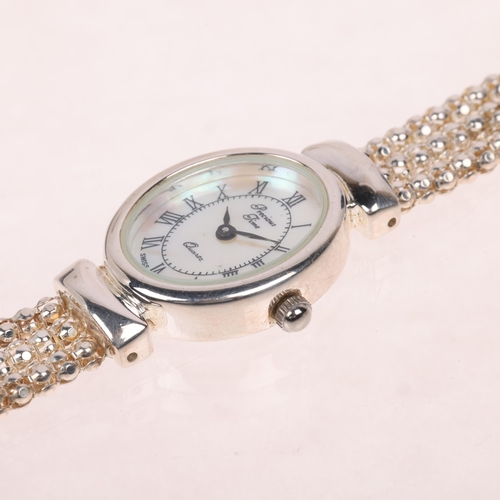 1073 - PRECIOUS TIME - a lady's stainless steel quartz bracelet watch, mother-of-pearl dial with Roman nume... 