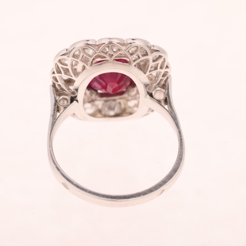 1183 - A French platinum ruby and diamond cluster cocktail ring, set with 4ct oval mixed-cut ruby surrounde... 