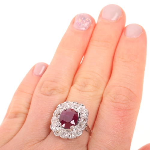 1183 - A French platinum ruby and diamond cluster cocktail ring, set with 4ct oval mixed-cut ruby surrounde... 