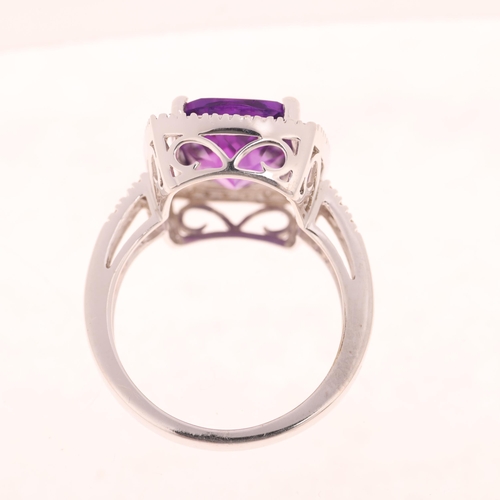 1193 - A 14ct white gold amethyst and diamond halo cluster ring, maker UB, London 2014, claw set with oval ... 