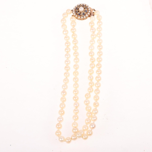 1201 - A Vintage double-strand cultured pearl bead necklace, with 9ct rose gold sapphire and pearl flowerhe... 