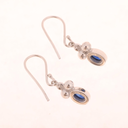 1219 - JANE M WATLING - a pair of 18ct white gold sapphire drop earrings, maker JMW, London 1999, set with ... 