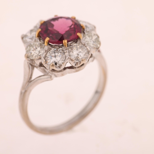 1225 - An 18ct white gold pyrope garnet and diamond flowerhead cluster ring, claw set with 2ct round-cut ga... 