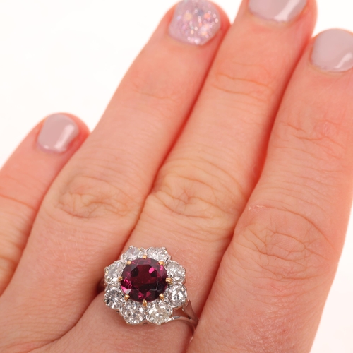 1225 - An 18ct white gold pyrope garnet and diamond flowerhead cluster ring, claw set with 2ct round-cut ga... 