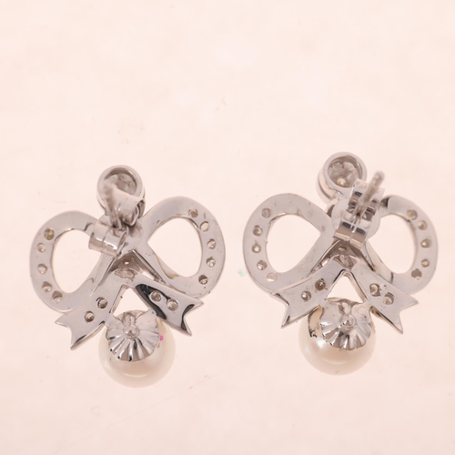 1230 - A pair of 18ct white gold whole pearl and diamond ribbon bow stud earrings, set with modern round br... 