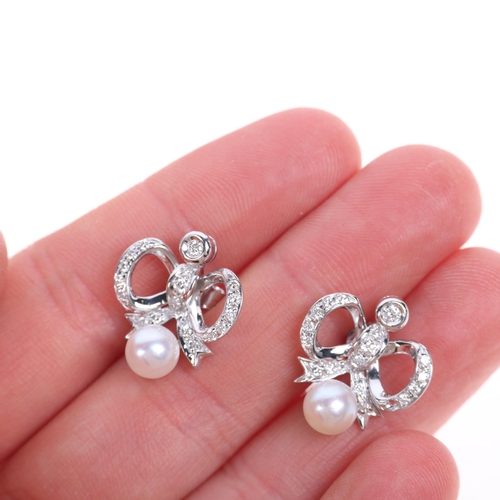 1230 - A pair of 18ct white gold whole pearl and diamond ribbon bow stud earrings, set with modern round br... 