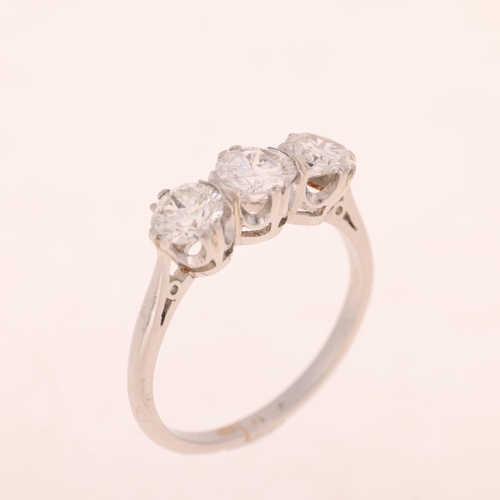 1236 - A platinum three stone diamond ring, claw set with modern round brilliant and transitional-cut diamo... 