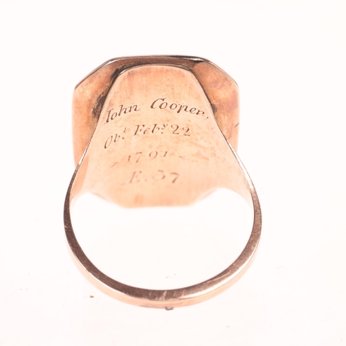 1252 - An Antique Georgian 9ct rose gold hairwork mourning ring, circa 1790, the elongated octagonal panel ... 