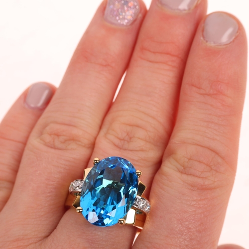 1255 - An 18ct gold blue topaz diamond cocktail ring, claw set with oval mixed-cut topaz and modern round b... 