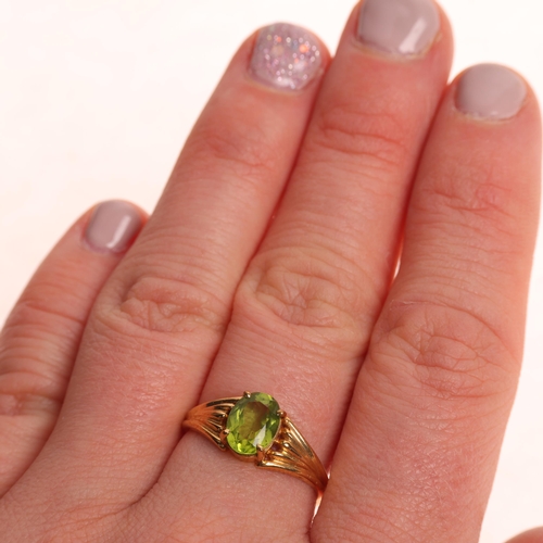 1264 - A 9ct gold single stone peridot dress ring, maker CG&S, Birmingham 1985, claw set with oval mixed-cu... 