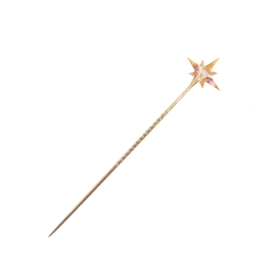 1321 - An Antique Victorian 18ct gold pearl starburst stickpin, circa 1860, modelled as an 8-ray star with ... 